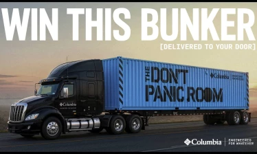 Columbia branded long-haul truck carrying the "Don't Panic Room" survival bunker.