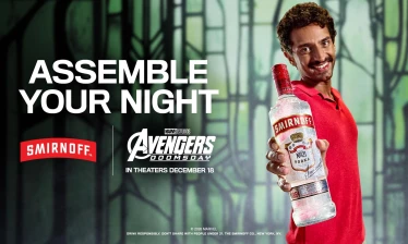 Man holding a Smirnoff bottle against the Avengers: Doomsday background.