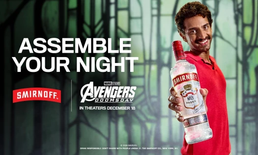 Man holding a Smirnoff bottle against the Avengers: Doomsday background.