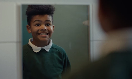 Kid putting on a brave face in the mirror