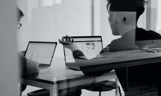 Colleagues discussing Adobe stocks after Figma's acquisition