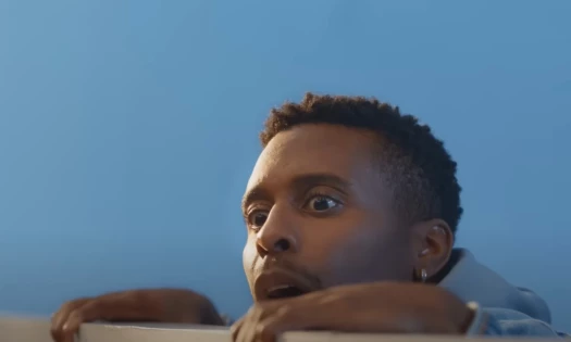 Scene from Samsung On the Fence campaign, man looking over fence