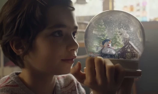 Girl looks into snowglobe