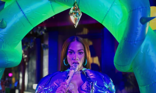 Anitta singing into microphone