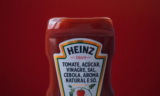 Heinz ketchup bottle pictured on red background