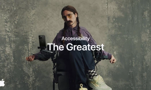 Photo of man in wheelchair using iPhone