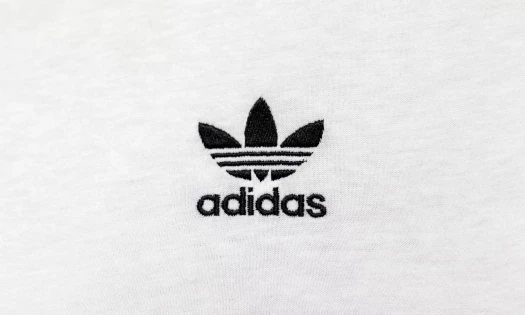Black Adidas logo on white material