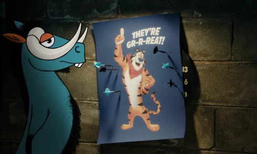A decorative image of a Kellogg character Newt the Gnu starting at a poster of Tony the Tiger