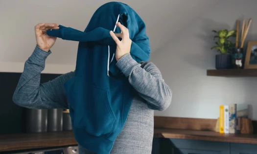 Mystery celebrity with hoodie covering his head