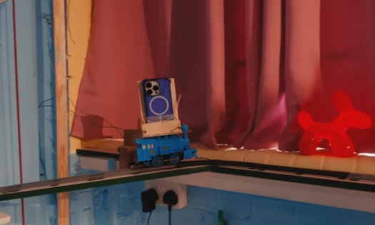 A screenshot from the Casetify video showing an iPhone riding a toy train