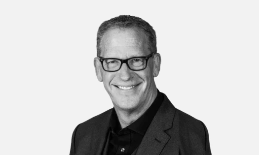 Nick Burns black and white headshot on a white background.