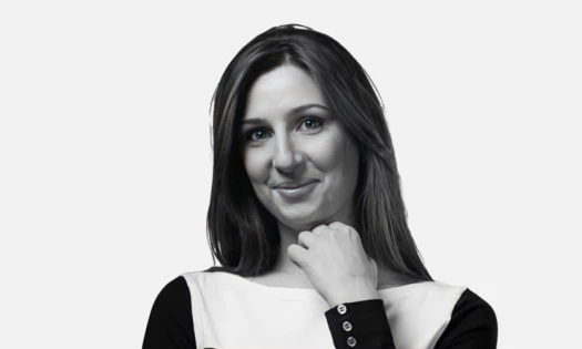 Black and white close up picture of Lusine Harutyunyan in a grey background.