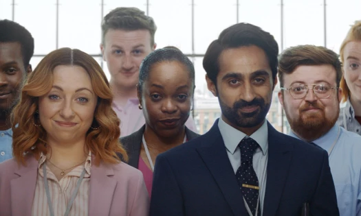 Office employees with raised eyebrows look towards camera