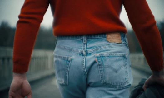 Man in Levi's 501 jeans and red sweater