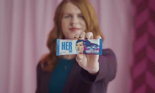 Far Johnstone holding limited-edition Her for She Hershey chocolate bar
