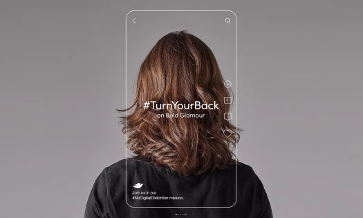 Woman facing backward with Dove #TurnYourBack on Bold Glamour frame in the shape of a smartphone