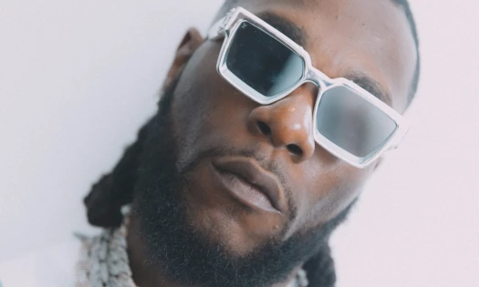 Burna Boy wearing silver sunglasses