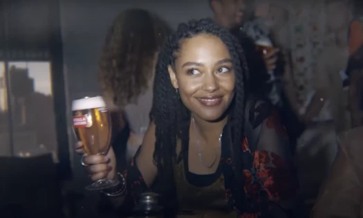 Woman holding Stella Artois beer at party