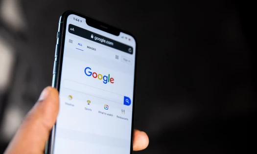 hand holding phone on Google site