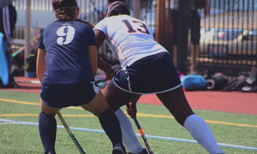 women playing field hockey