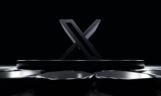Large, dark grey X logo in front of black background