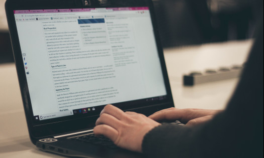 A person typing on a laptop