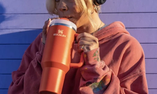 Woman Sipping from a Red Stanley Tumbler