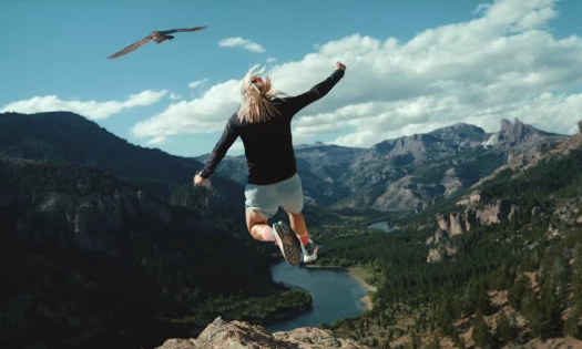 A Woman Trail Running in Hoka Shoes