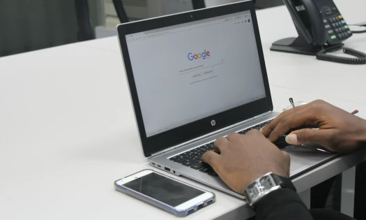 Man Using Laptop to Search on Google