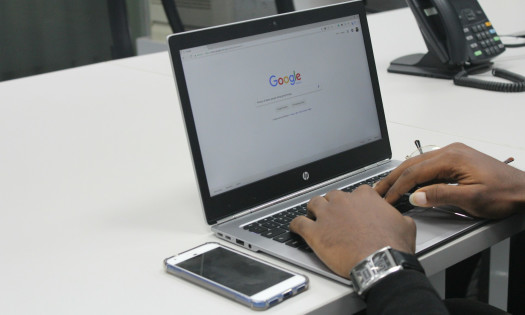 Man Using Laptop to Search on Google
