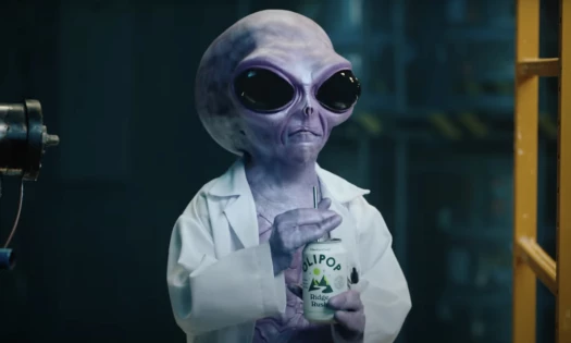 An alien in an Olipop ad