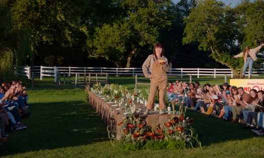 A lady stands on a giant Land O'Lakes butter bar