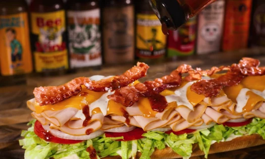 A Firehouse Sub getting doused in hot sauce