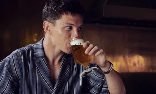 Tom Holland chugs new BERO non-alcoholic beer from a glass