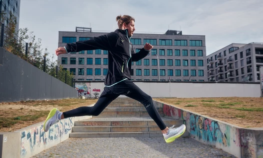 DJ Chris Luno runs through the streets of Berlin wearing HOKA's running shoes