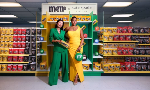 Two women model the M&M's x Kate Spade New York capsule collection
