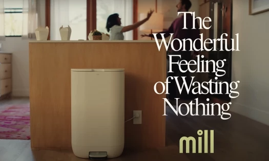 A man and a woman in the kitchen with Mill food recycler
