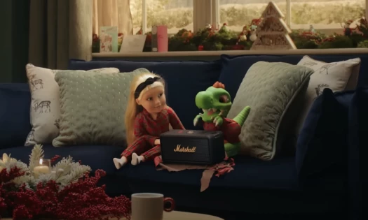 Connie the Doll & Trevor the Dinosaur sitting on a couch on Christmas Day