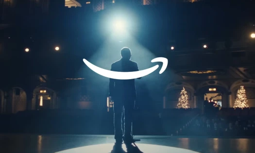 A janitor singing on stage and the Amazon logo