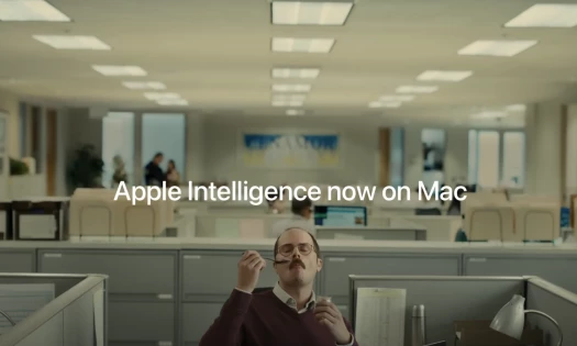 A man eats his pudding at work with the text: 'Apple Intelligence now on Mac'