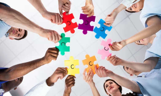 people holding different colored puzzles pieces labelled 'c'