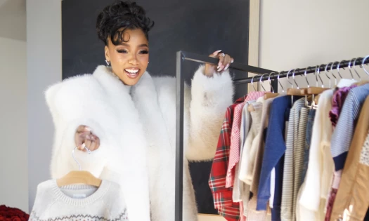 Chloe Bailey with a rack of children's clothes from Carter's