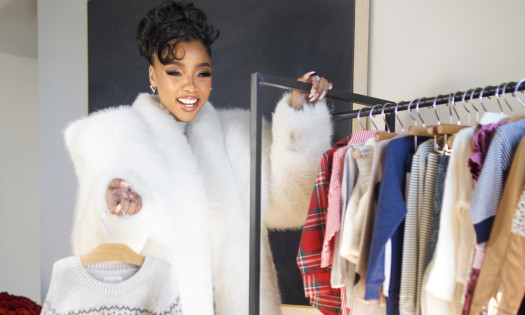 Chloe Bailey with a rack of children's clothes from Carter's