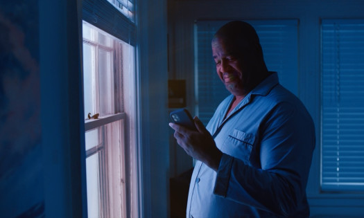 Man smiling at his phone