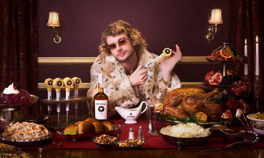 Yung Gravy holds a Skrewball Whiskey baster shot