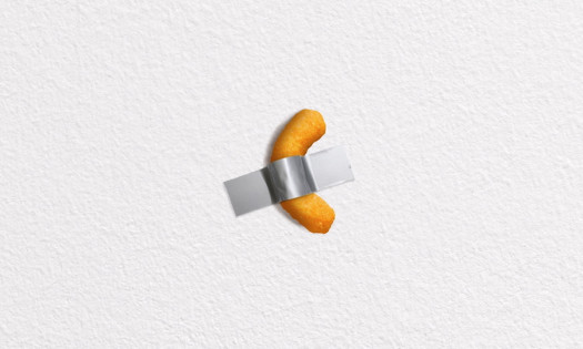 Cheetos with duct-taped to a white wall