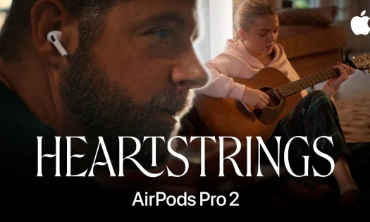 Dad wearing Airpods Pro 2 while daughter plays the guitar