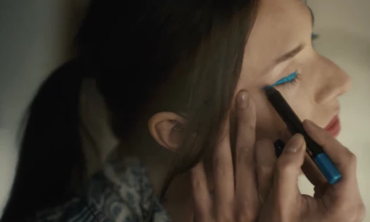 Woman putting on Sephora makeup.