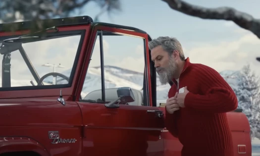 Kris checking his Target ID on his red jeep's sideview mirror