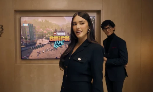 Madison Beer doing a presentation with LEGO Fortnite: Brick Life in the background